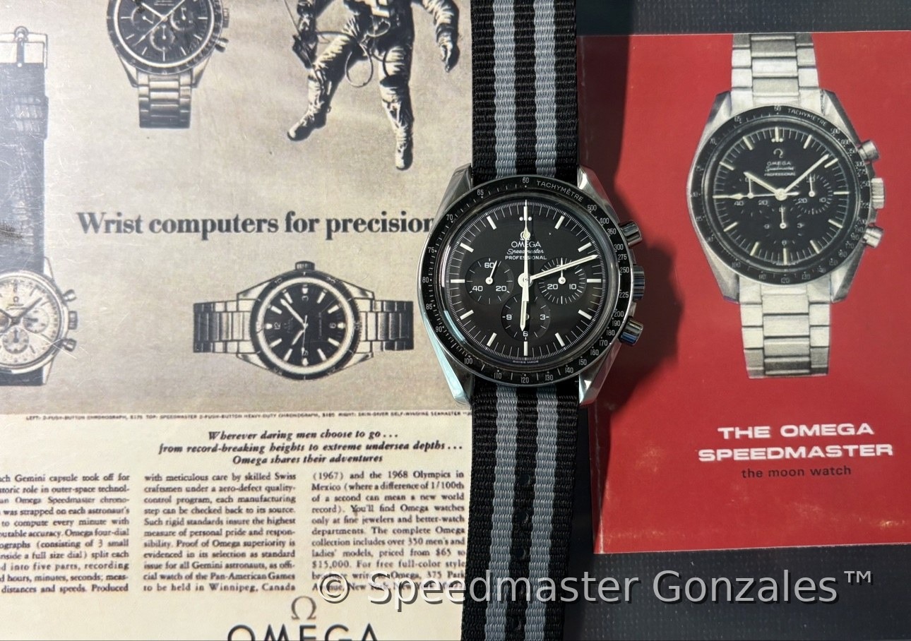 The collector's Speedmaster on a strap, laid over vintage Omega advertisements