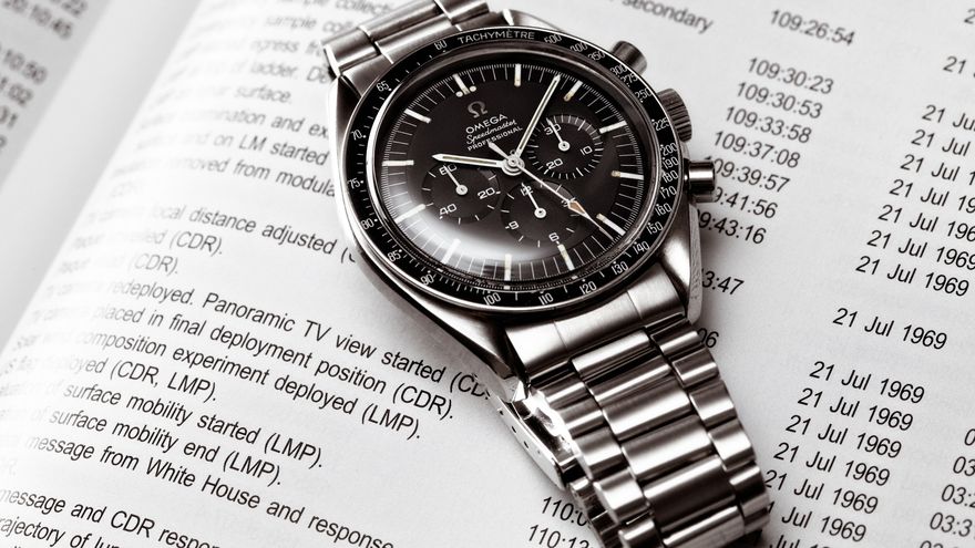 Vintage Omega Speedmaster 145.012-67 resting on an Apollo 11 mission timeline