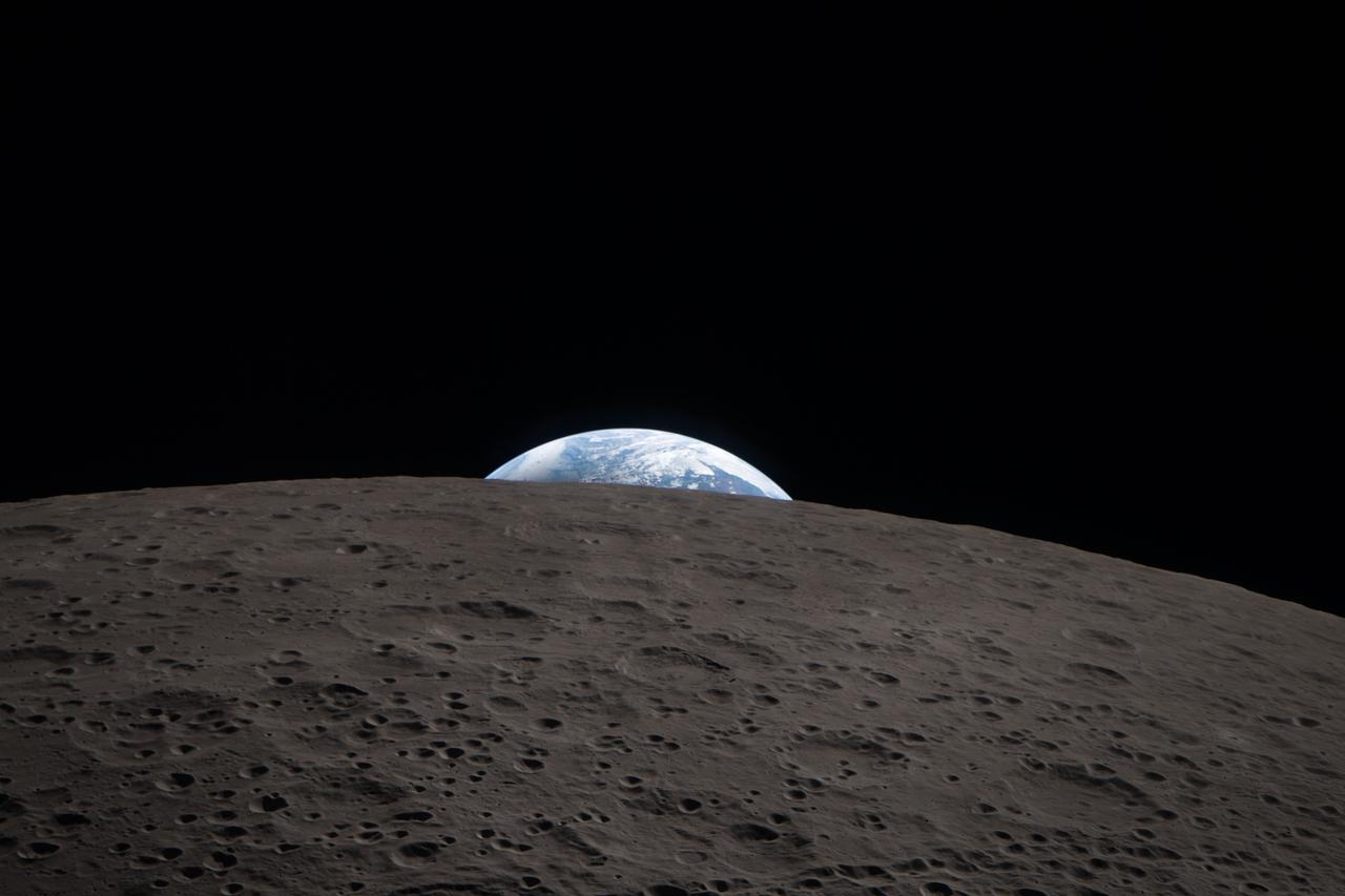 Earth setting beyond the Moon, photographed from the Orion capsule