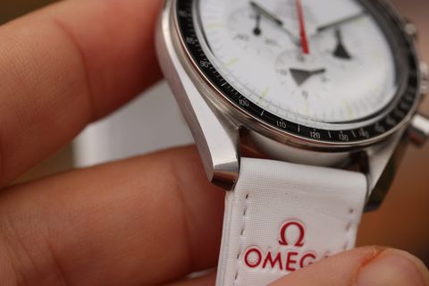 Three-quarter view — black tachymetre bezel against the white dial