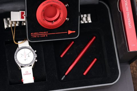 The red Alaska tin: tools, spare strap, and the watch