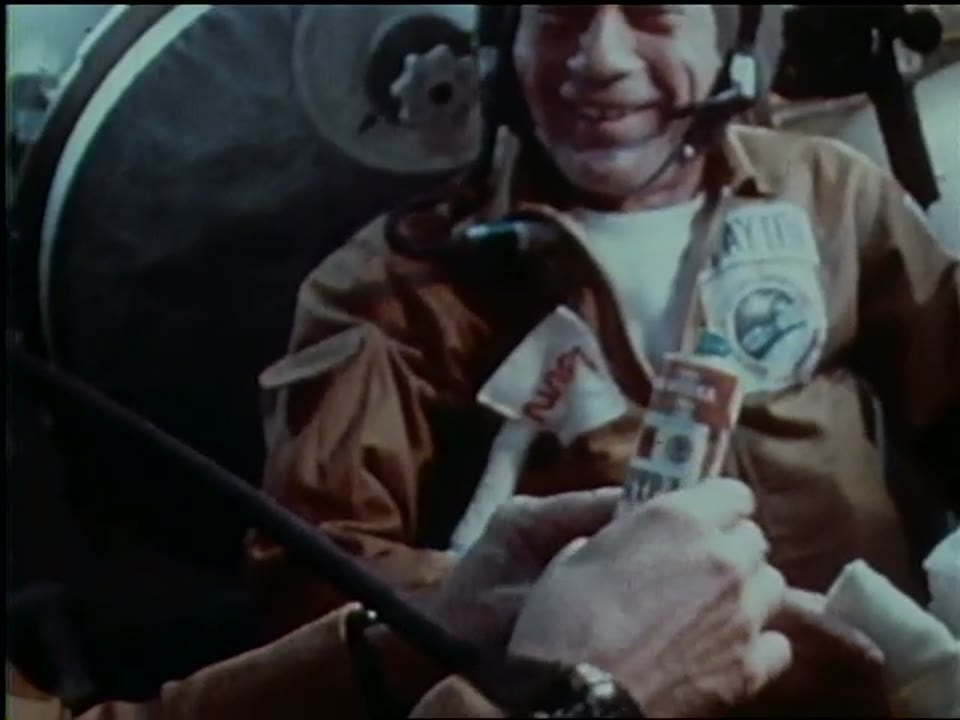 A smiling cosmonaut during the crew gift exchange aboard the docked Apollo-Soyuz spacecraft