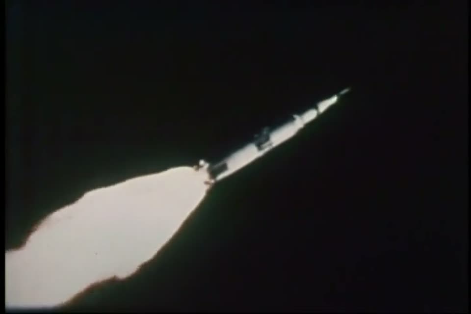 The Saturn V climbing on a pillar of flame at night