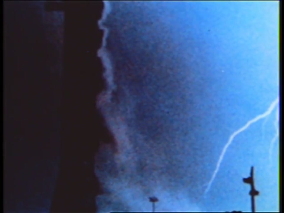 A lightning bolt arcing beside the ascending Saturn V