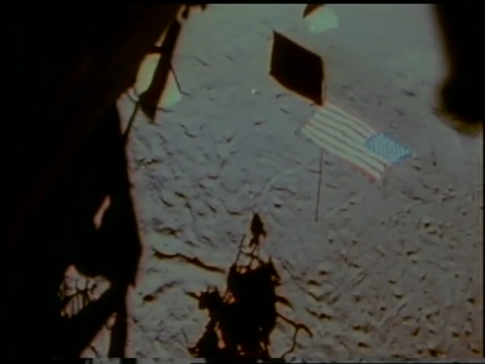 The planted U.S. flag with the lunar module's shadow at Fra Mauro