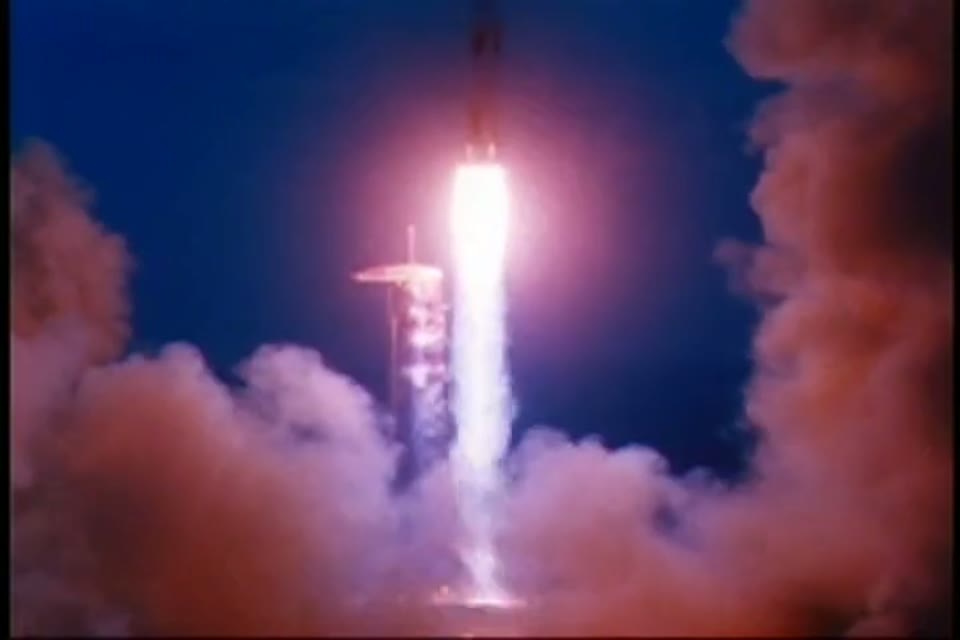 The Saturn V climbing through flame and smoke on the uncrewed Apollo 4 test flight