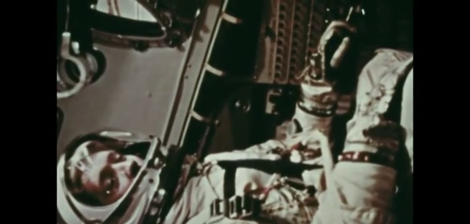 An astronaut strapped into the Gemini mission simulator couch during training