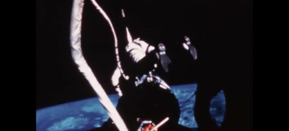 Astronaut Buzz Aldrin on his umbilical spacewalk, tethered above the Earth