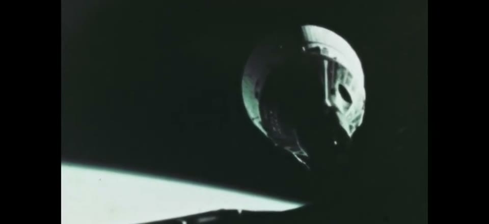 Gemini VII seen from Gemini VI during the first orbital rendezvous, Earth's horizon below