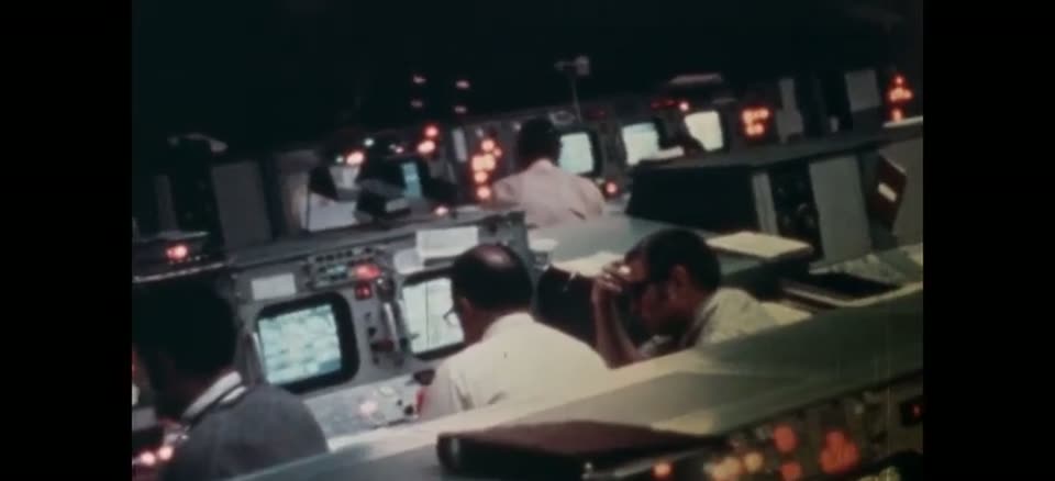 Flight controllers at their consoles during a Skylab mission