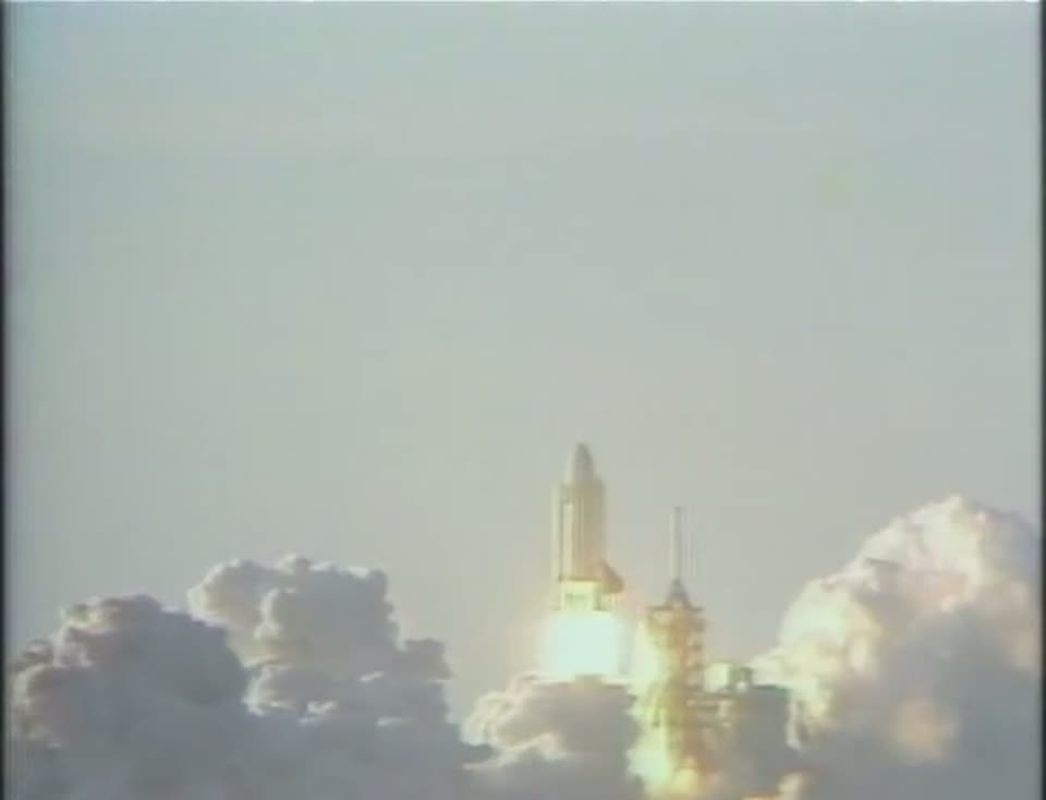 Space Shuttle Columbia rising through smoke at liftoff